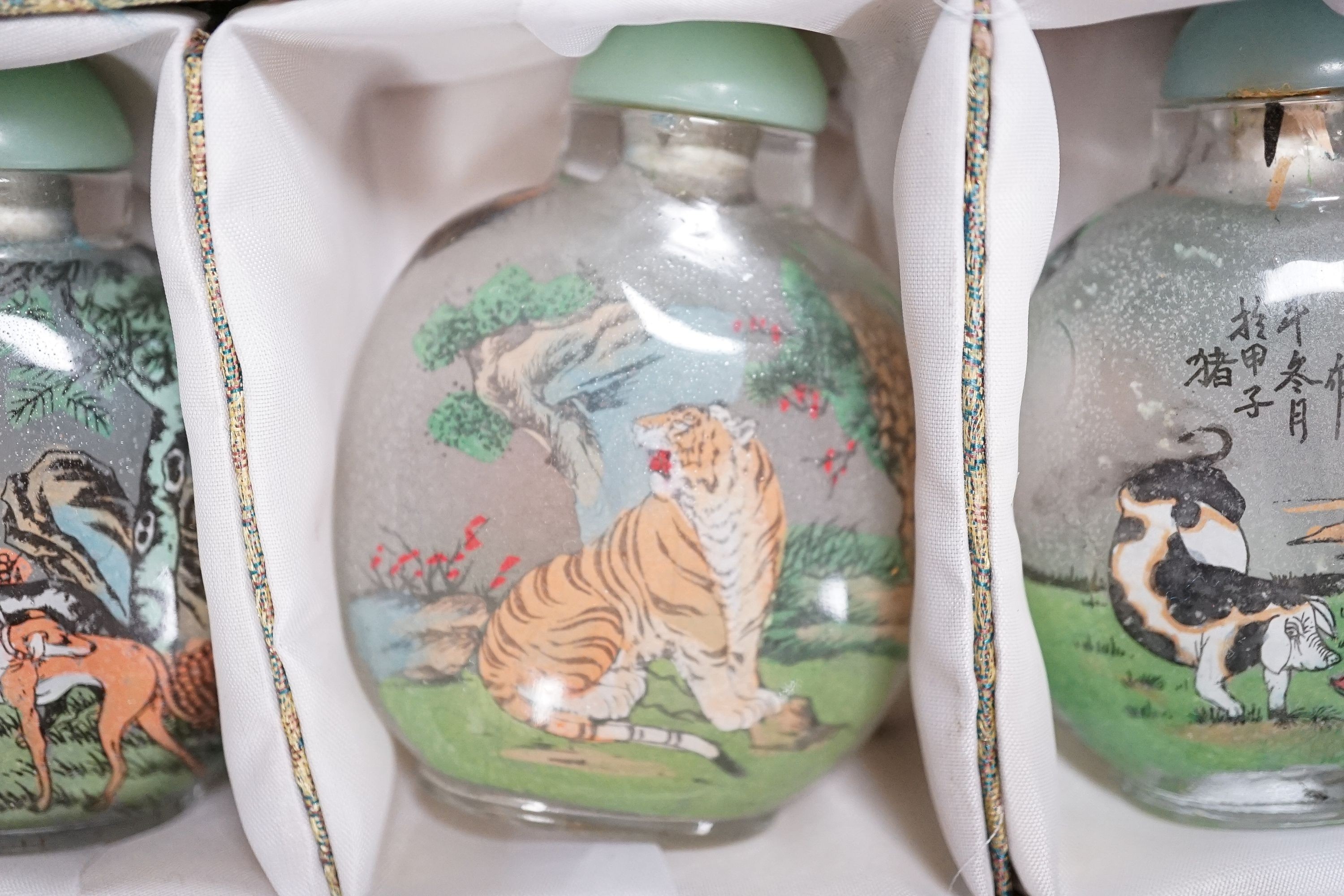 A boxed set of six Chinese inside-painted snuff bottles, height 8cm overall